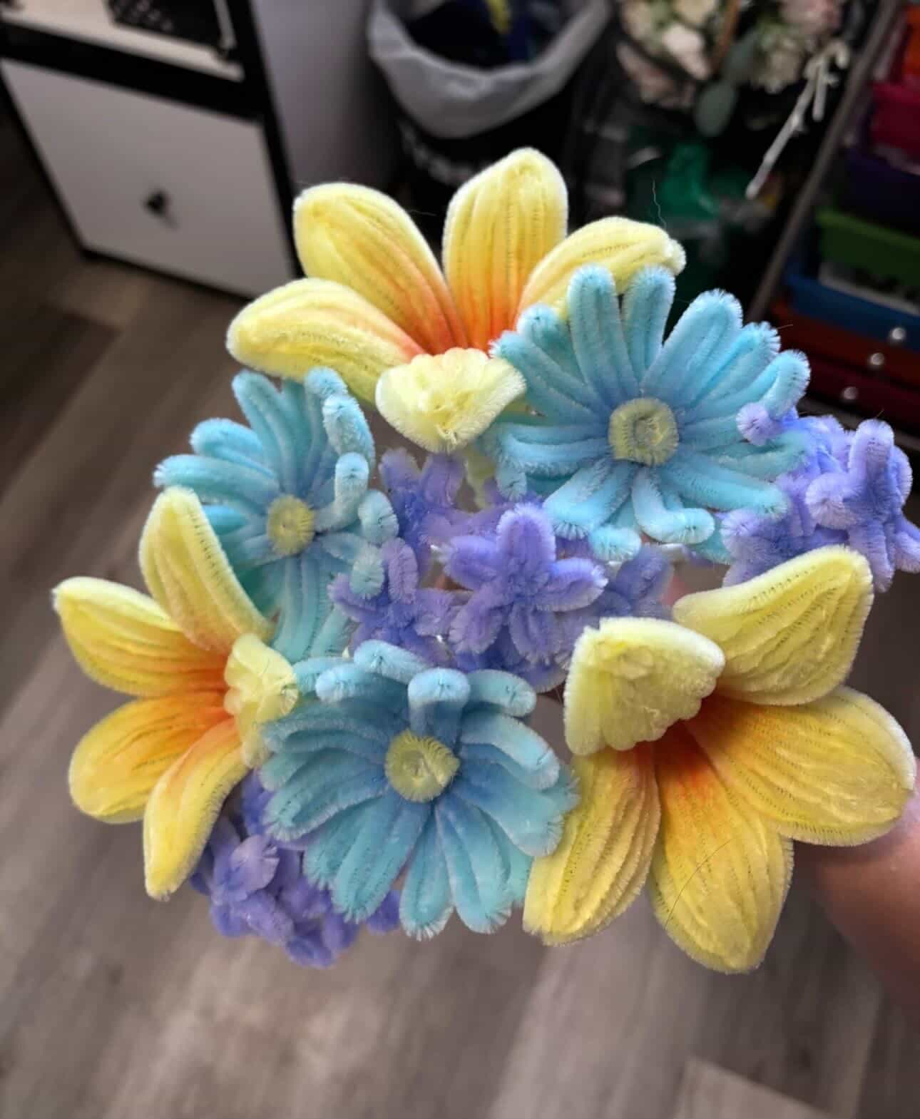 Colorful pipe cleaner flower bouquet in yellow, blue and purple