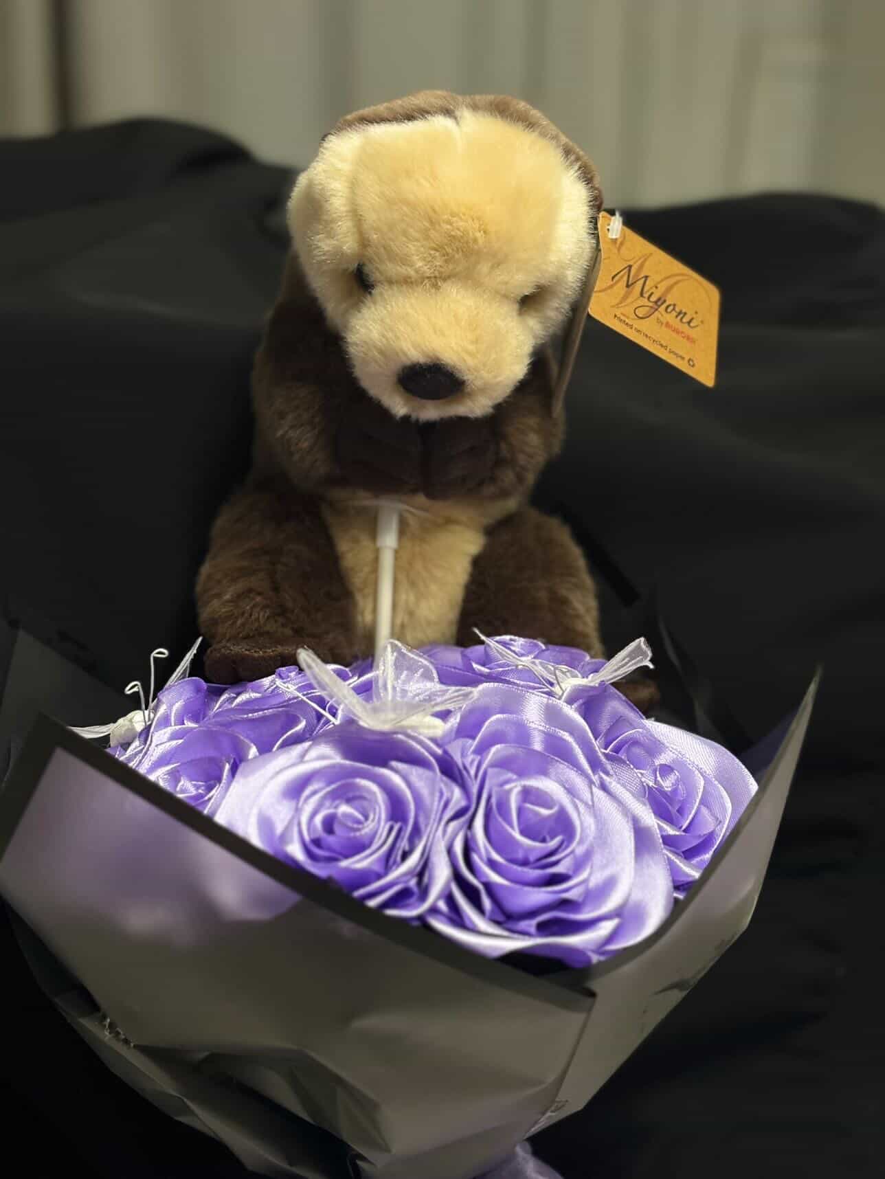 Lavender ribbon rose bouquet with otter plushie